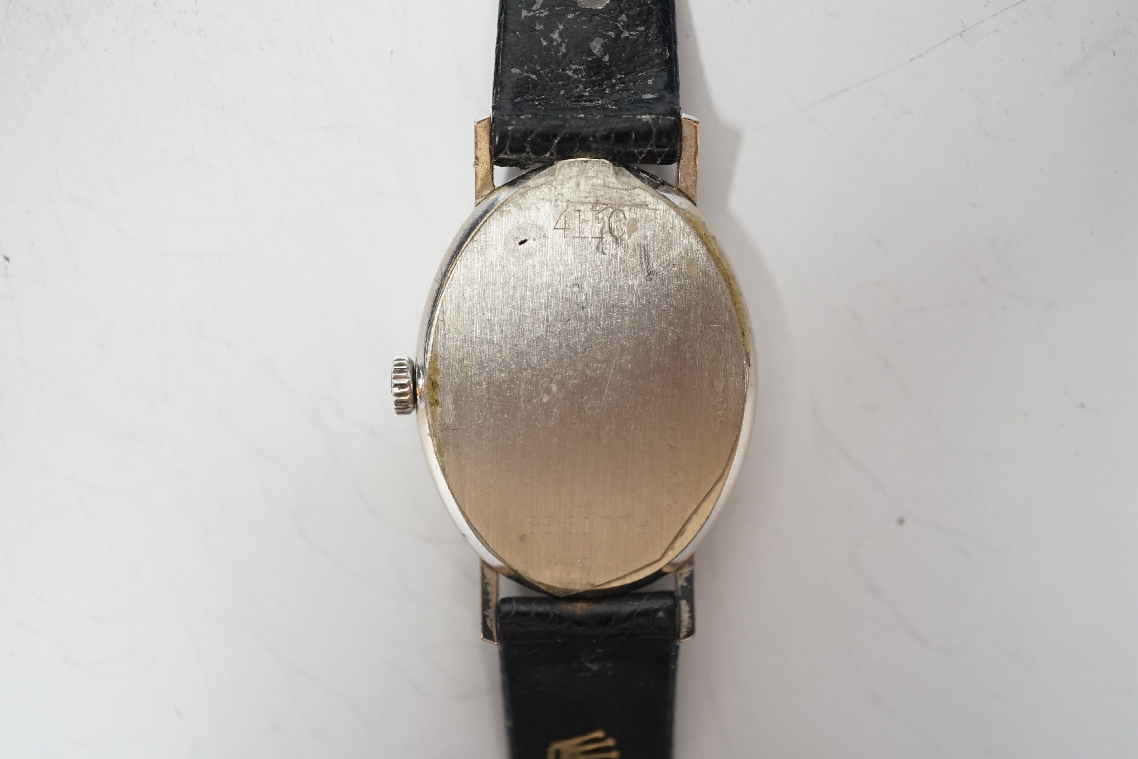 A lady's modern 18k Rolex Cellini manual wind oval wrist watch, with baton numerals, on a leather Rolex strap with 18k Rolex buckle, with original purchase receipt , Rolex Guarantee and Service statement, no box, case di